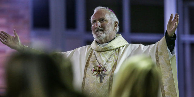 Bishop David O'Connell of St. Cornelius Catholic Church hosts a community memorial service.