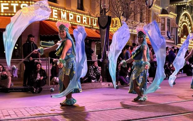 Jenn Acevedo, left, performs as an ocean dancer in the Magic Happens parade at Disneyland. (Disney)