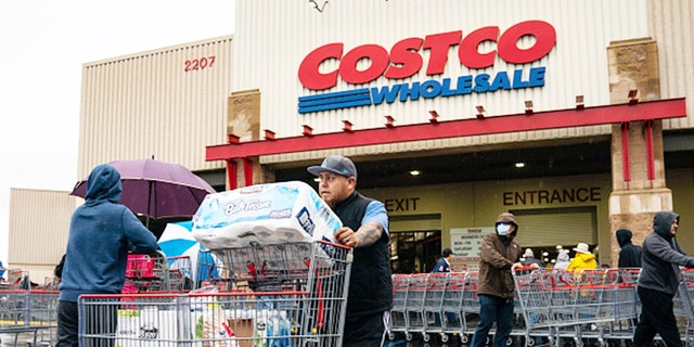 A man pushes a trolley outside a Costco supermarket in Los Angeles.