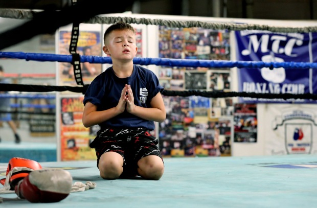 Boxer Victor Vasquez, 7, takes time to rest his arms after doing 100 pushups in the ring while training at M.T.C. Boxing Club in San Bernardino on Monday, Oct. 17, 2022. (Photo by Terry Pierson, The Press-Enterprise/SCNG)