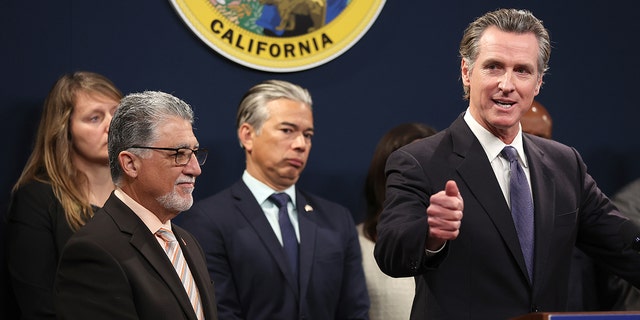 California Gov. Gavin Newsom, right, speaks as state Senator Anthony Portantino (D-Burbank), left, and California Attorney General Rob Bonta, center, look on during a press conference.