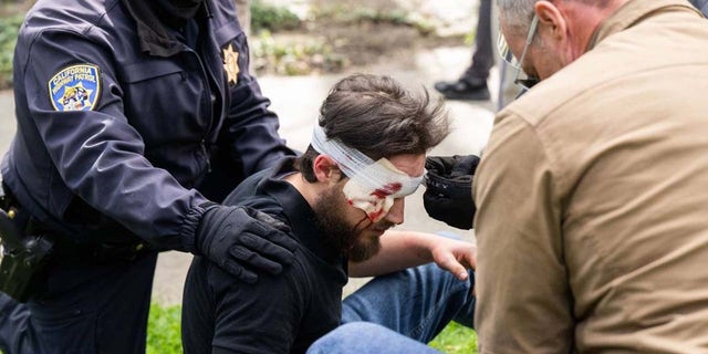 State Capitol California Highway Patrol officers tend to an injured man last Friday after he was clubbed by a member of the Pride Was A Riot trans activist march.