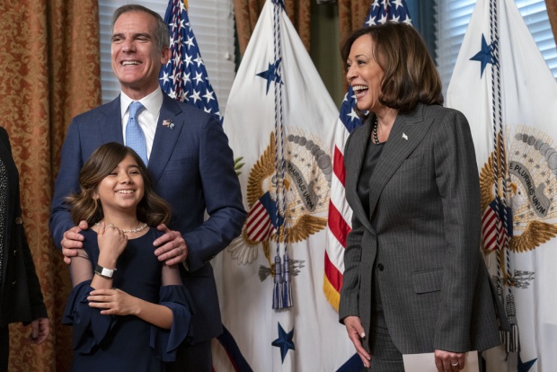 Eric Garcetti, left, with his daughter Maya Garcetti, reacts after being sworn in as Ambassador to India by Vice President Kamala Harris, right, Friday, March 24, 2023, in Harris' ceremonial office in the Eisenhower Executive Office Building on the White House complex in Washington. (AP Photo/Jacquelyn Martin)