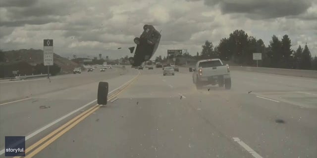 The Kia flipped over in the air and landed on its roof.