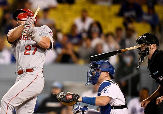 Home plate umpire Nate Tomlinson is hit in the face by a broken bat from Mike Trout #27 of the Los Angeles Angels as catcher Will Smith #16 of the Los Angeles Dodgers looks on in the ninth inning of a MLB baseball game at Dodger Stadium in Los Angeles on Tuesday, June 14, 2022. (Photo by Keith Birmingham, Pasadena Star-News/ SCNG)