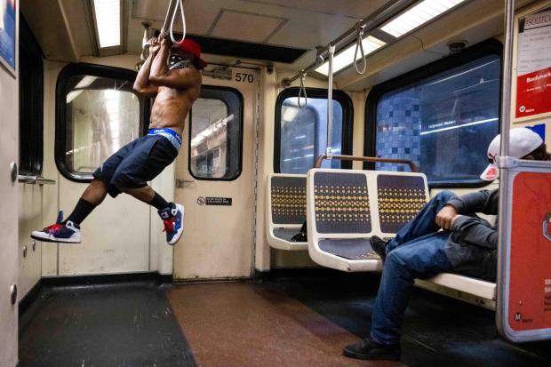 Frank does pull-ups as he rides the Metro B (Red) Line in Los Angeles on Tuesday, November 1, 2022 saying he does them from the time he gets on until he gets off. According to a Metro survey fewer females are riding transit. (Photo by Sarah Reingewirtz, Los Angeles Daily News/SCNG)