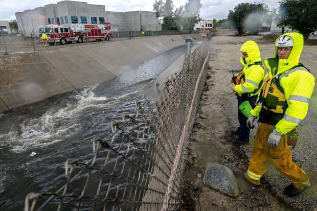 Firefighters look for people trapped in the rain-swollen Cucamonga wash in Ontario on Nov. 8, 2022. Several homeless people were rescued. (Photo by Watchara Phomicinda, The Press-Enterprise/SCNG)