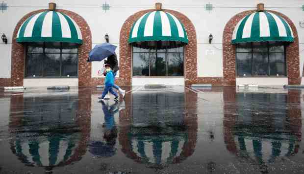 People walk past Star Ballroom Dance Studio in Monterey Park on Friday, March 10, 2023 the scene of a mass shooting where 11 were killed in January. (Photo by Sarah Reingewirtz, Los Angeles Daily News/SCNG)