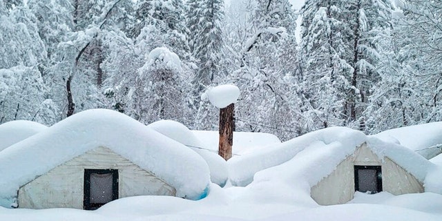 In this photo provided by the National Park Service, tents at Curry Village are covered with snow in Yosemite National Park, Calif., Tuesday, Feb. 28, 2023. The park, closed since Saturday because of heavy, blinding snow, postponed its planned Thursday, March 2, 2023, reopening indefinitely. 