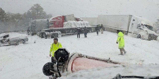 This photo provided by the Arizona Department of Transportation shows multiple vehicles snarled by a winter storm on Interstate 40 near Williams, Ariz., on Wednesday, March 1, 2023. 