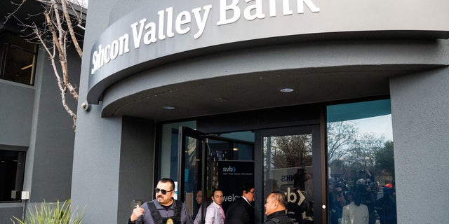 Security guards and FDIC representatives open a Silicon Valley Bank (SVB) branch for customers in Santa Clara, California, on March 13, 2023.