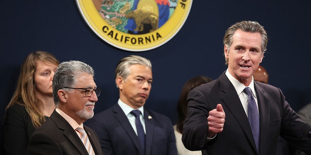 California Gov. Gavin Newsom (R) speaks as state Senator Anthony Portantino (L) (D-Burbank) and California Attorney General Rob Bonta (C) look on during a press conference on February 1, 2023 in Sacramento, California. 