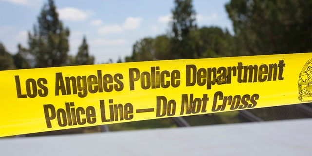 Yellow tape surrounds a crime scene in Los Angeles.