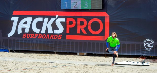 Brett Simpson of Huntington Beach stretches out before surfing in a heat of the fifth annual Jack's Surfboards Pro in Huntington Beach in 2022. Surfers from around the world will compete in the contest on April 6, 2023 through Sunday, April 9.(Photo by Mark Rightmire, Orange County Register/SCNG)