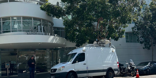 A man stands outside the Portside building in San Francisco, where Cash App founder Bob Lee was found early Tuesday with stab wounds that later resulted in his death.