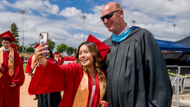 Graduate Melanie Cruz Peralta takes a selfie with Loara High principal Gary Brown after the Loara High School graduation ceremonies in Handel Stadium at Western High School in Anaheim on Thursday, May 25, 2023. (Photo by Leonard Ortiz, Orange County Register/SCNG)