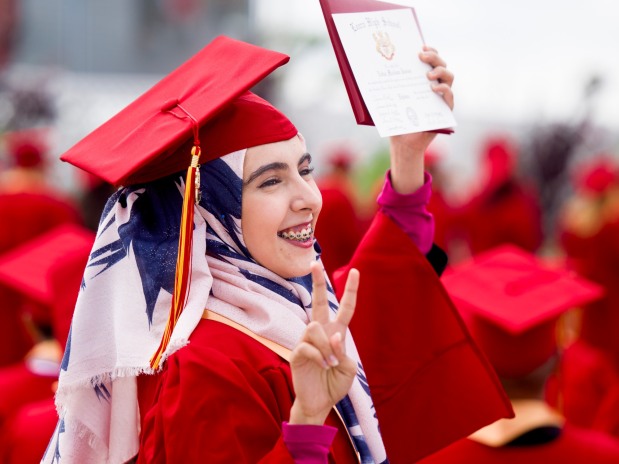 Nabaa Jassam flashes a victory sign to her family after receiving her diploma during the Loara High School graduation ceremonies in Handel Stadium at Western High School in Anaheim on Thursday, May 25, 2023. (Photo by Leonard Ortiz, Orange County Register/SCNG)