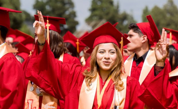 Linda Perez, center, raises her hand as she joins other graduates in the singing of the school's alma mater at the conclusion of the Loara High School graduation ceremonies in Handel Stadium at Western High School in Anaheim on Thursday, May 25, 2023. (Photo by Leonard Ortiz, Orange County Register/SCNG)