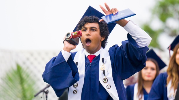 Jayden Varghese uses a camcorder to document himself receiving his diploma during the Oxford Academy graduation ceremonies in Handel Stadium at Western High School in Anaheim on Tuesday, May 23, 2023. (Photo by Leonard Ortiz, Orange County Register/SCNG)