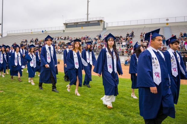 Graduates walk into Handel Stadium during the Oxford Academy graduation ceremonies at Western High School in Anaheim on Tuesday, May 23, 2023. (Photo by Leonard Ortiz, Orange County Register/SCNG)