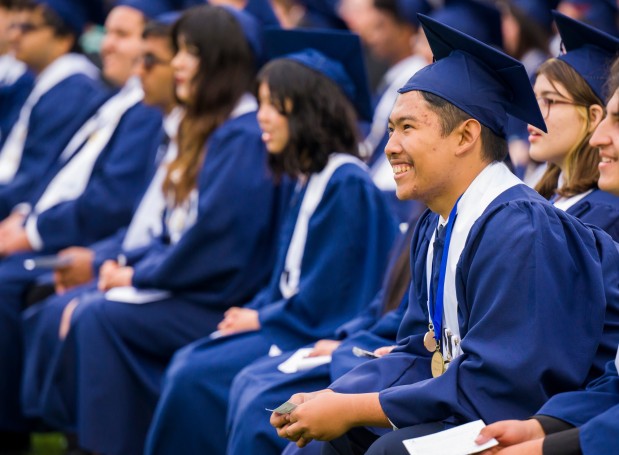 Sufyan Asari, right, laughs as graduates watch a Class of 2022 memories slide show during the Oxford Academy graduation ceremonies in Handel Stadium at Western High School in Anaheim on Tuesday, May 23, 2023. (Photo by Leonard Ortiz, Orange County Register/SCNG)