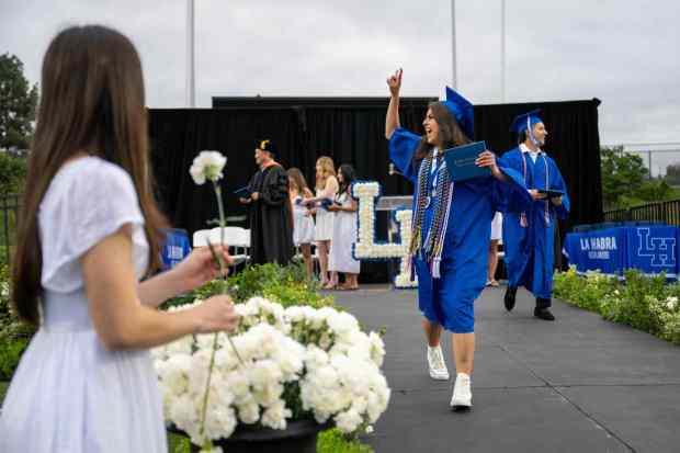 Senior Aysha Gracida waves to family and friends after receiving a diploma during the La Habra High School graduation ceremony on Wednesday, May 31st, 2023. (Photo by Michael Ares, Contributing Photographer)