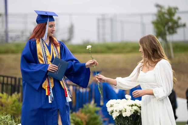 Senior student Caprice Cannery, left, receives a white carnation after receiving a diploma during the La Habra High School graduation ceremony on Wednesday, May 31st, 2023. (Photo by Michael Ares, Contributing Photographer)