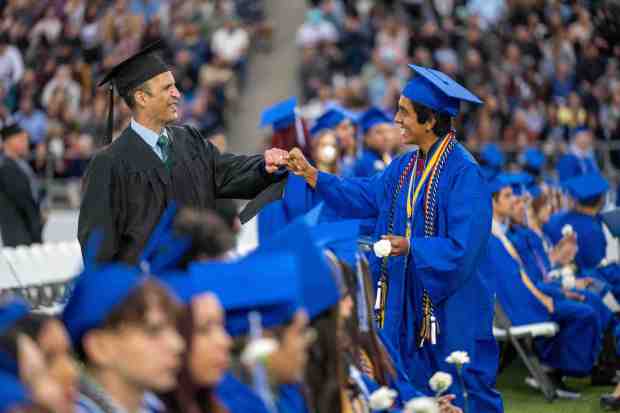 Senior student Mario Mendoza, right, receives a fist bump from Principal Steve Garcia, left, during the La Habra High School graduation ceremony on Wednesday, May 31st, 2023. (Photo by Michael Ares, Contributing Photographer)