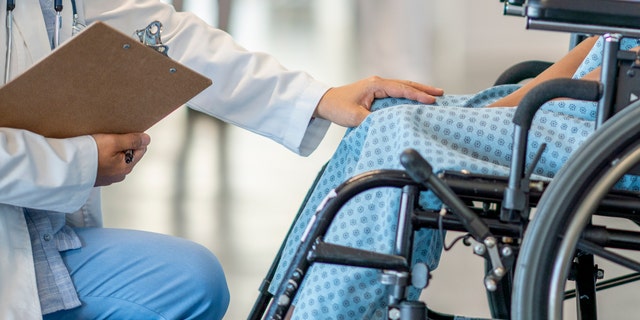 Doctor with patient in wheelchair