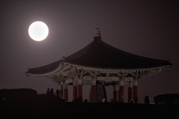 A blue supermoon rises over the Korean Friendship pagoda in San Pedro, CA, Wednesday, August 30, 2023.  It was the second full moon of August, thus the blue label. And it was unusually close to Earth, therefore a supermoon. The next blue supermoon isn't until 2037. But another regular supermoon is on the horizon at the end of September, the last one of the year.  (Photo by David Crane, Los Angeles Daily News/SCNG)