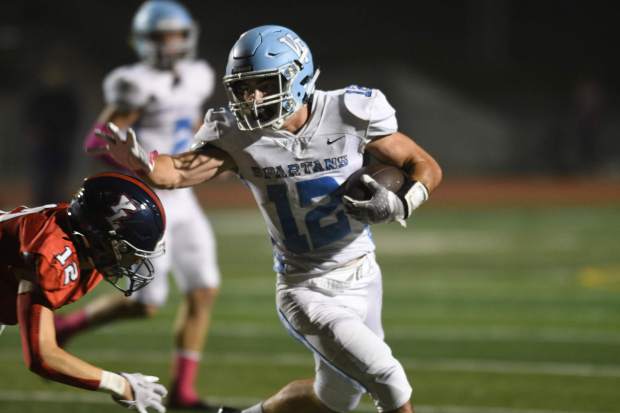 Villa Park's Carter Christie straight arms a Yorba Linda defender in their game Friday night. Villa Park vs. Yorba Linda in a Crestview League football game at Yorba Linda HS. Photographed on Friday, 10/14/2022 in Yorba Linda, California. (Photo by Michael Kitada, Contributing Photographer)