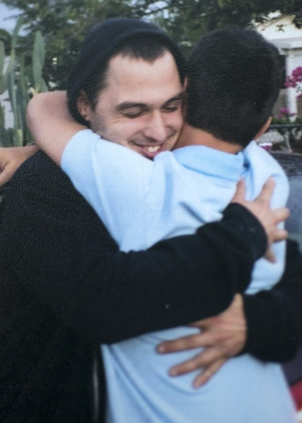 Identical twins Ronald Moore, at left and Ryan Morris, embrace after seeing each for first time in 13 years during a July 2015 court hearing. (Photo courtesy of Monica Mukai)