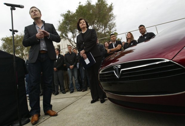 Tesla Motors co-founder Elon Musk, left, answers questions as Sen. Dianne Feinstein looks on during the official reopening ceremony of the former NUMMI auto plant by the new owners inFremont, Calif., on Wednesday, October 27, 2010. The electric car company plans to build its Model S sedan at the plant. (Anda Chu/Staff Archives)