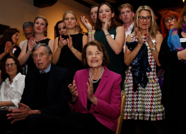 U.S. Senator Dianne Feinstein, with her husband Richard Blum, listens to her introduction at her election night party in San Francisco, Calif., on Tuesday, November 6, 2018. (Karl Mondon/Staff Archives)