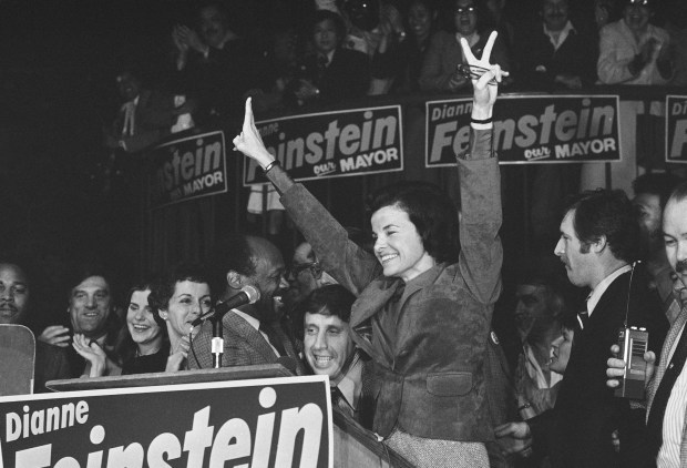 FILE - San Francisco Mayor Dianne Feinstein, named mayor following the assassination of late Mayor George Moscone, in San Francisco, Dec. 12, 1979. With her on the victory platform are, from left, Moscone's widow, Gina Moscone, Assemblyman Willie Brown and Feinstein's fiancé, Richard Blum. Democratic Sen. Dianne Feinstein of California has died. Three people familiar with the situation confirmed her death to The Associated Press on Friday, Sept. 29, 2023. She was 90.(AP Photo/Sal Veder, File)