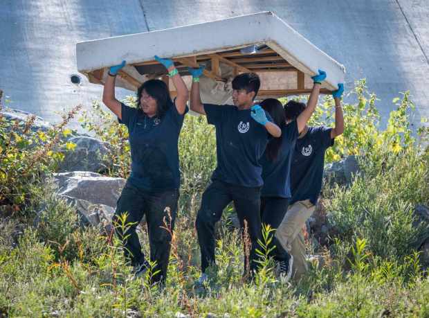 Students from San Juan Hills High School remove a box-spring from San Juan Creek during the 39th Annual California Coastal Cleanup Day on Saturday, September 23, 2023 at Descanso Park in San Juan Capistrano.