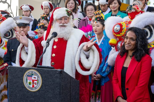 Cortney Lofton, as Santa Claus, speaks while Los Angeles City Councilmember Nithya Raman enjoys the moment, during a press conference for the 91st Anniversary of the Hollywood Christmas Parade Supporting Marine Toys for Tots at the Ovation Hollywood in Hollywood, CA on Monday, November 20, 2023. (Photo by Hans Gutknecht, Los Angeles Daily News/SCNG)