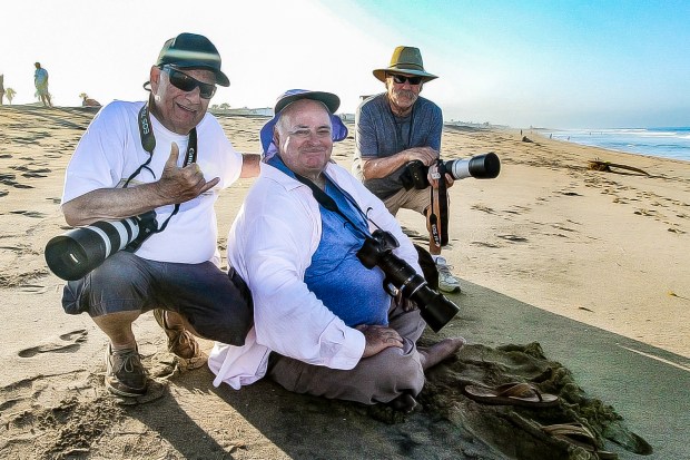 Longtime surf photographer Mike Moir, center, who documented decades of surf culture including the rise of Newport's Echo Beach in the 80s, died on Monday, Nov. 13, 2023. (Photo courtesy of Ron Lyon Photo)