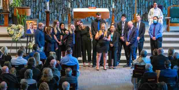 Colleagues in the Orange County Public Defender's Office who worked with Elliot Blair, the former Orange County deputy public defender who died recently under mysterious circumstances in Mexico, gather in front of hundreds during the memorial service for Blair at the Christ Cathedral Church in Garden Grove on Saturday, February 11, 2023. (Photo by Mark Rightmire, Orange County Register/SCNG)