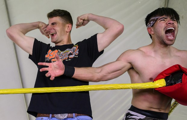 Camp Pendleton Marine Pfc. Will Tully, left, shows off his prowess in the ring with American Professional wrestler Lucas Riley, right, after winning an arm wrestling match with another wrestler. About 500 Marines were at a Super Bowl party sponsored by Crisp Imaging, Inc., at America Legion Harbor Post 291 in Newport Beach on Sunday, February 12, 2023. The wrestling show was just one of the festivities before the game. (Photo by Mindy Schauer, Orange County Register/SCNG)