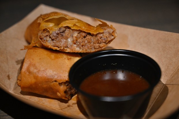 Quesabirria Eggroll with Guajillo pepper consommé filled with Oaxaca cheese, beef birria, and a side of guajillo pepper consommé available at Lucky 8 Lantern during Lunar New Year at Disney California Adventure in Anaheim, CA, on Jan. 20, 2023. (Photo by Jeff Gritchen, Orange County Register/SCNG)