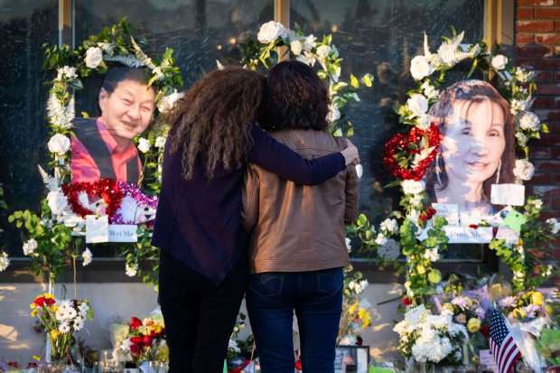 Dancer Adelle Castro, 68, of Temple City, left, hugs a woman in January 2023 at the memorial for the victims of the Monterey Park mass shooting at Star Ballroom Dance Studio, where 11 of her friends were killed. (File photo by Sarah Reingewirtz, Los Angeles Daily News/SCNG)