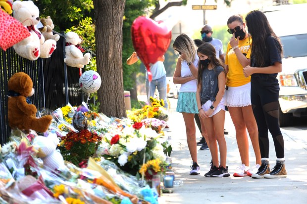 A memorial is growing for Mark and Jacob Iskander who were killed after being struck by a vehicle in a crosswalk at the intersection of Triunfo Canyon Road and Saddle Mountain Drive in Westlake Village, CA. Rebecca Grossman, a co-founder of the Grossman Burn Foundation, was arrested on suspicion of DUI and vehicular manslaughter in connection with the crash and was released from jail Thursday morning.(photo by Andy Holzman)