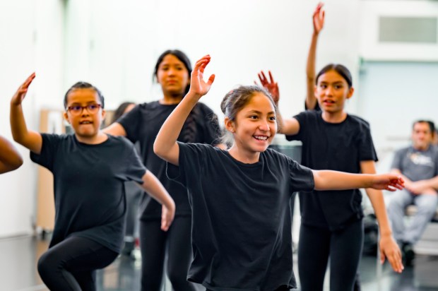 Students from The Wooden Floor follow the dance steps of performer Sameola xe2x80x9cSammyxe2x80x9d Andriamalalaharijaona from xe2x80x9cSmall Island Big Songxe2x80x9d during a master class in Santa Ana on Friday, Feb. 2, 2024. The Wooden Floor partnered with Chapman Universityxe2x80x99s Musco Center for the Arts to provide six master classes to all The Wooden Floor student, free of charge. xe2x80x9cSmall Island Big Songxe2x80x9d is an artistic collective of singers, musicians, and dancers from island nations in the Indian and Pacific Oceans that perform their traditional dances and songs. Small Island Big Song will be performing at the Musco Center for the Arts on Feb. 3. (Photo by Leonard Ortiz, Orange County Register/SCNG)