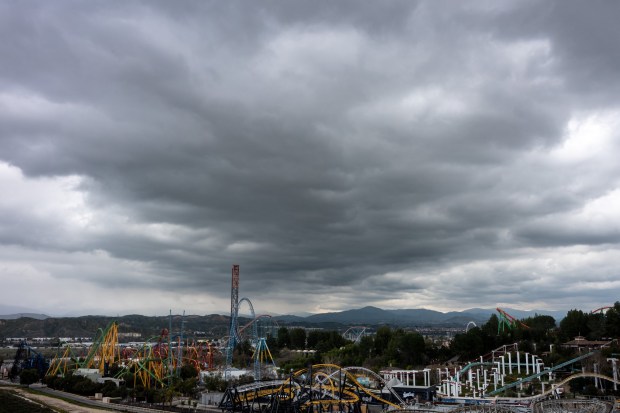 Dark clouds move over the Six Flags Magic Mountain amusement park on Wednesday, March 6, 2024, in Valencia.  More rain is expected throughout the region through Thursday morning. (Photo by David Crane, Los Angeles Daily News/SCNG)