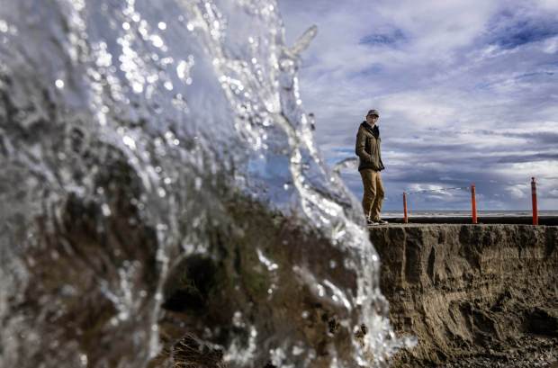 Todd Moore of Costa Mesa checks out the rain-eroded road leading to San Onofre State Beach on Tuesday, Feb. 6, 2024.(Photo by Mindy Schauer, Orange County Register/SCNG)