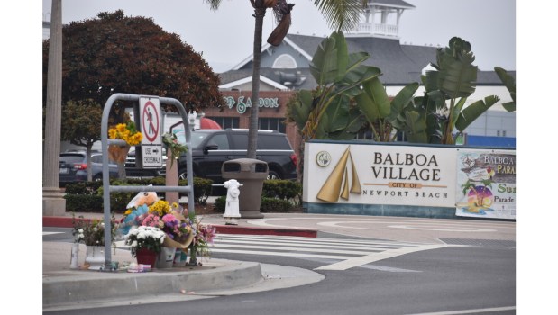 Flowers and candles adorn a sidewalk on Tuesday, May 28, near the scene of a weekend accident on the Balboa Peninsula that killed a 14-year-old girl. (Photo by Mark Evans/SCNG)